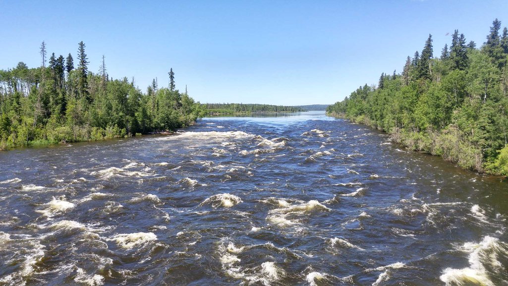 Photo of rapids on the Churchill River on a sunny summer day in Saskatchewan's northern forest