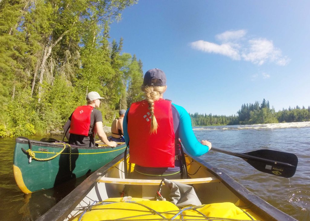 POV view of being in a canoe with Ashlyn sitting in front while on the river