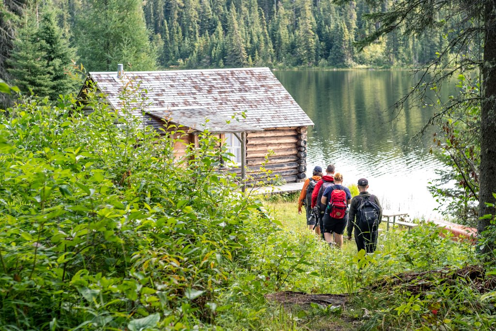 four hikers walking towards Grey Owls cabin on Grey Owl Trail in Prince Albert National Park