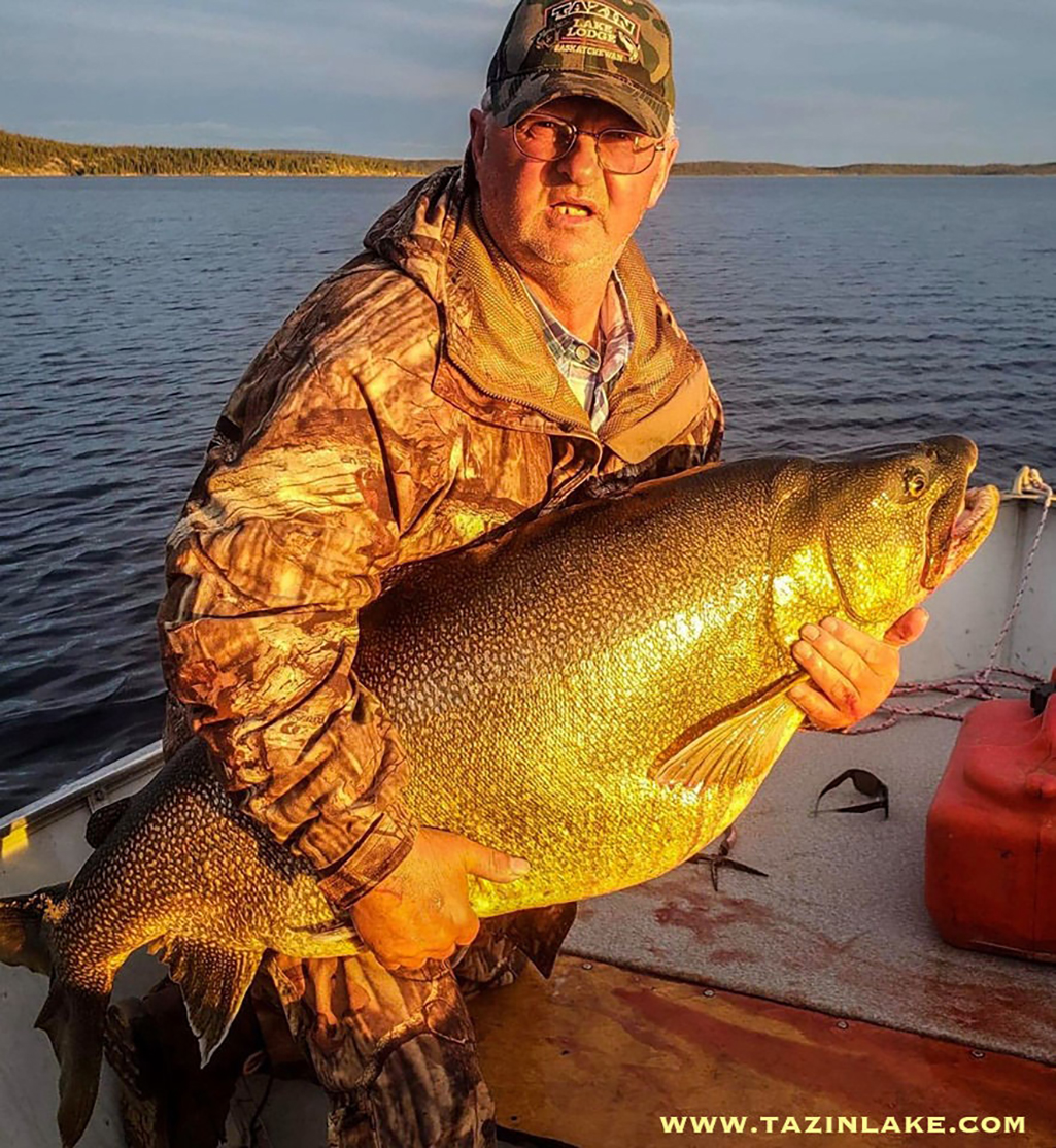 A man holds a huge 72 pound lake trout he caught on Tazin Lake in Northern Saskatchewan