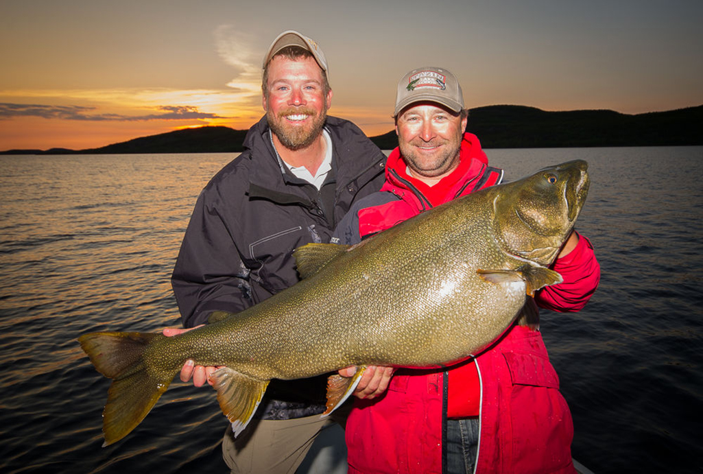Bret Amudson holds a huge lake trout he caught on Tazin Lake Saskatchewan. Beside Bret is Scott Montgomery, owner and guide at Tazin Lake Lodge.