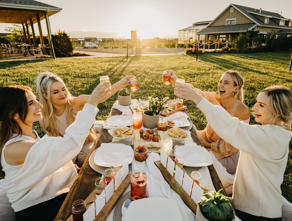 Picture of a group of friends cheering with their glasses of cider from Crossmount Cider Company 