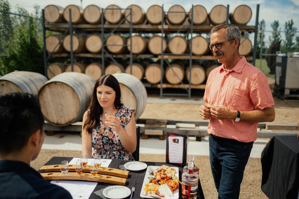 Picture of a couple at Black Fox Farm receiving a hosted spirits tasting