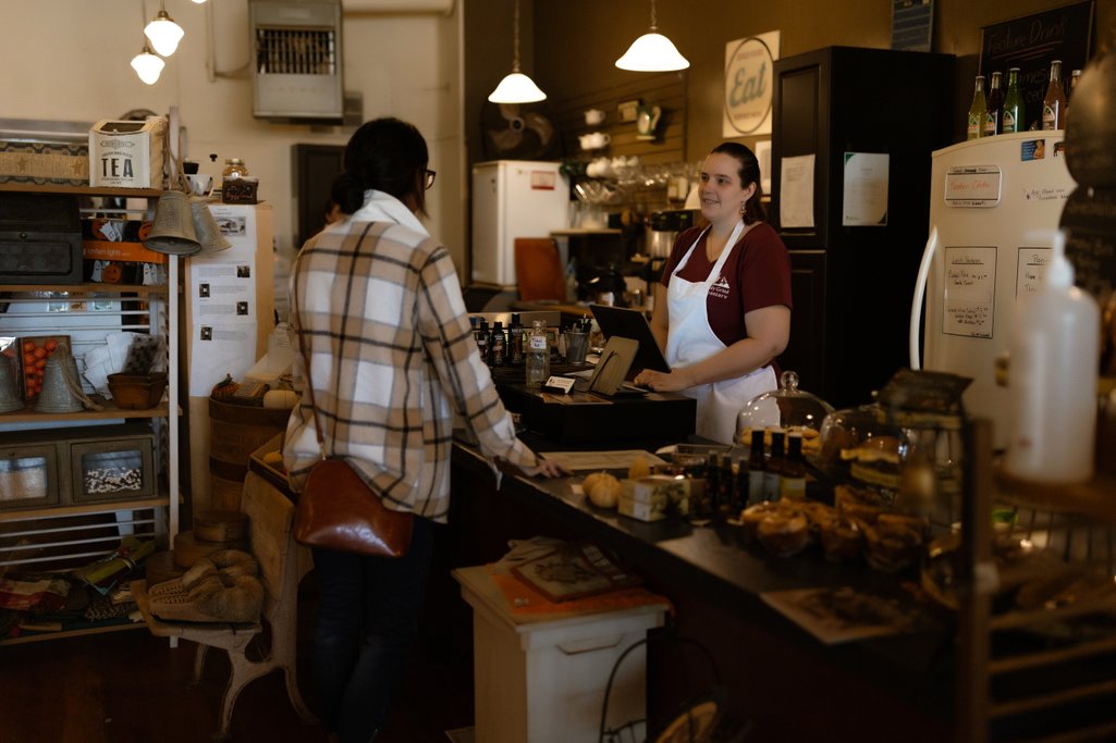 picture inside Daily Grind coffee shop with a person being helped at the counter